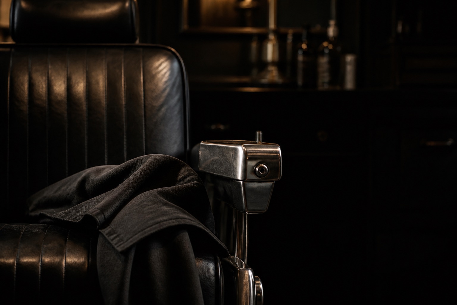 Black leather barber chair detail in warm light